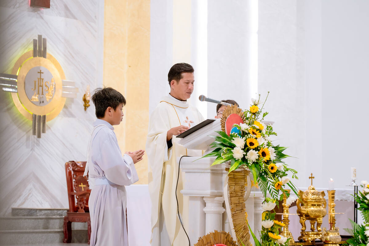 Thầy giúp lễ bên cạnh cha chủ tế tại giảng đài